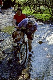 Colin & Jennifer Woodman running aground on their tandem at the ford near Cross Furzes