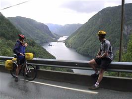 Gavin and Michael at the Lovra Viewpoint, with Lovra Fjord in the foreground and Lovre Lake beyond, 21.2 cycling miles into the ride