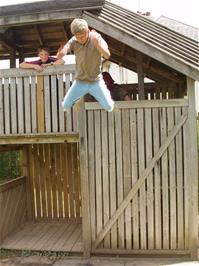 Jordan performs a death-defying leap off Broadhempston Play Park's fort