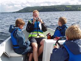 Olly in control of our motor boat on Lake Windermere