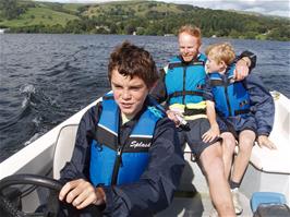 Freddie takes the controls of our hire boat on Lake Windermere