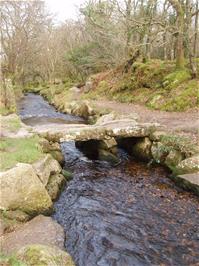 The stone clapper bridge at the bottom of the valley, over the Becka Brook