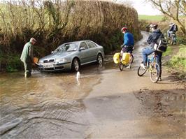 No, he hasn't got stuck in the flood - he's washing his car!