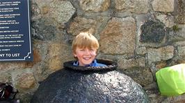 Olly tries out this ancient artefact at the Shipwreck Heritage Centre, Charlestown