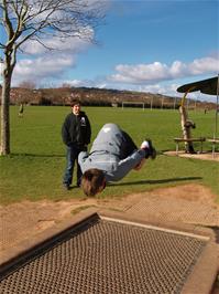 Ashley does a flip on the trampoline