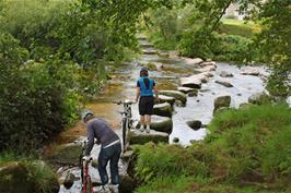 Ash and Callum start the tricky crossing of the West Dart River stepping stones near Dartmeet