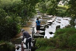 Ash and Callum start the tricky crossing of the West Dart River stepping stones near Dartmeet