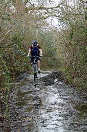 Ash negotiates the muddy upper reaches of the Lower Hembury Track - new photo for 2024