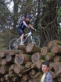 Ash rides the log pile on the Holne Woods track