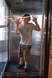 Will traps Lawrence inside the revolving entrance doors at Solothurn Youth Hostel