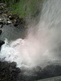 A view of Giessbach Falls from underneath the waterfall