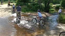 A family of cyclists cross the ford with no difficulty