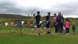 George & Dillan try their hands at archery at Old Sarum