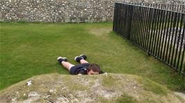 Dillan does his best to hide behind one of the mounds in Old Sarum's Keep
