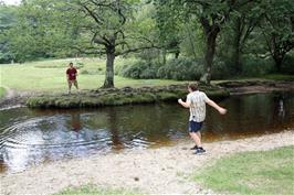 Lawrence and Dillan playing frisbee across the Ober Water at Puttles Bridge near Brockenhurst, 7.4 miles into the ride