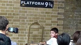 Posing for photos at Platform 9¾, King's Cross station, London