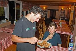 Lawrence tastes his home-made flapjack, made for Michael's birthday, at Helmsley youth hostel