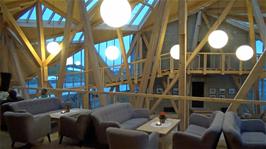 The lounge inside the Sognefjellshytta overlooking the icy lake and entrance atrium