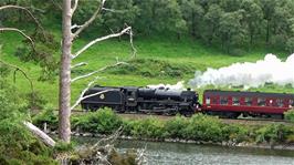 A steam train passes Loch Eilt on the way from Mallaig to Fort William