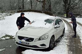 Removing snow from the car, moved to the bottom of the hostel driveway during the night by Michael