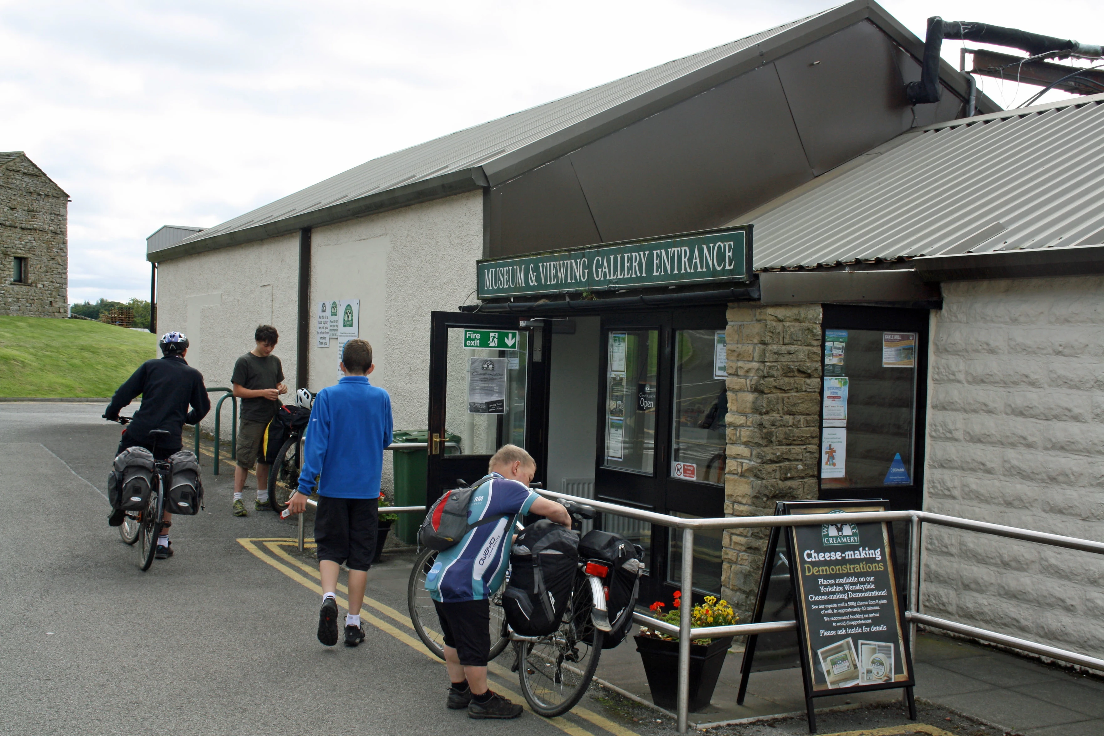 Preparing to leave Wensleydale Creamery Visitor Centre; bikes parked outside the museum opposite
