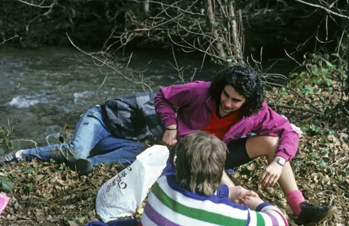 Vicky relaxes beside the River Avon while Luke lounges behind, lunch near Lower Reveton.