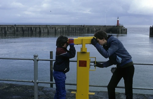 Philip and Jonothan peer at each other through the yellow harbour binoculars at Watchet after our cafe stop.