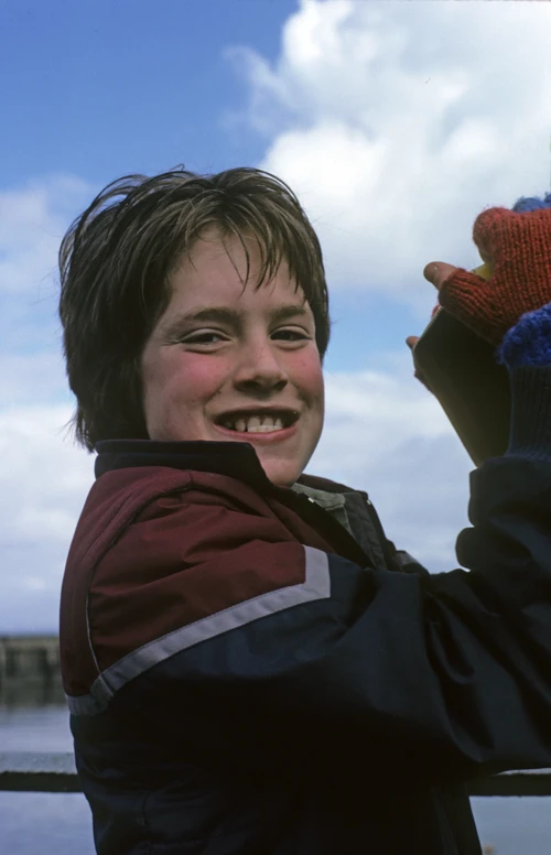 Philip Drew grins, clinging to the harbour binoculars on Watchet’s Esplanade.