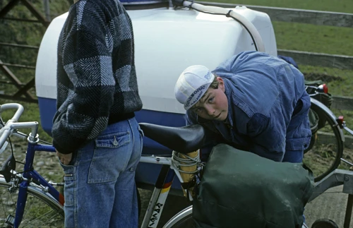 David Parry checks his patched-up bike near Umberleigh, with Luke Rake standing by off the A377.