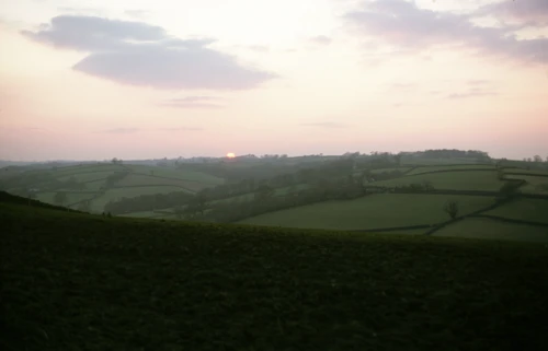 Sunset over the rolling hills near Hittisleigh as the day's light fades.