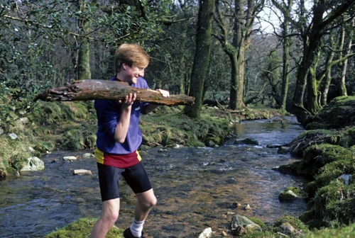 Richard Burge hefts a rotten log by Glaze Brook, trying to dislodge the dead branch near Owley.