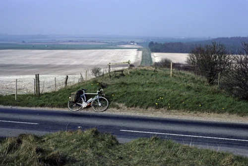 Ackling Dyke from the B3081 near Wyke Down. Michael's Mercian lounges by the stile.
