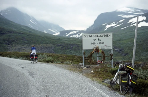 Start of the Sognefjellsvegen climb near Turtagrø Hotel, 10 miles, 930m. Snow beyond; sign says built in 1939.