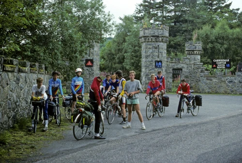 The group at the turreted lodge gates at the foot of the drive - Carbisdale Castle Youth Hostel by Culrain.