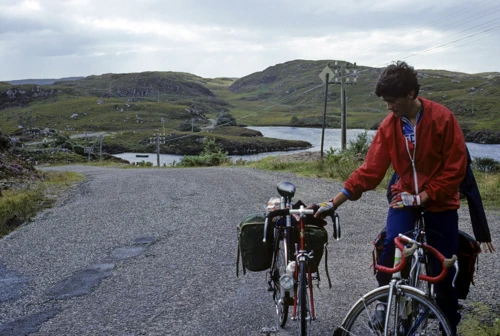 Andrew Brush holds Jeremy’s bike at Black Loch; Jeremy hides behind. ‘Mad Little Road’, 22 miles.