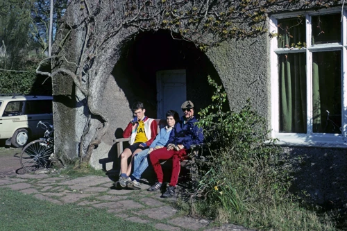 Simon Hopper, Trevor Piper and Mark Sloman basking on the bench in Holford Youth Hostel’s garden alcove.