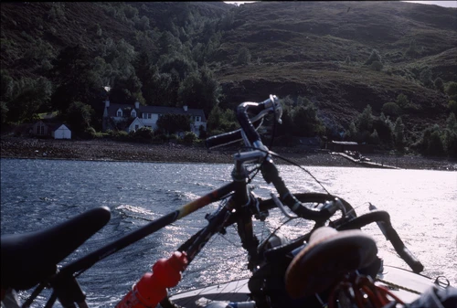 Bikes stacked on Mother Goose, the Altnaharrie Inn’s ferry, speeding across Loch Broom to Ullapool—shortcut of the day.