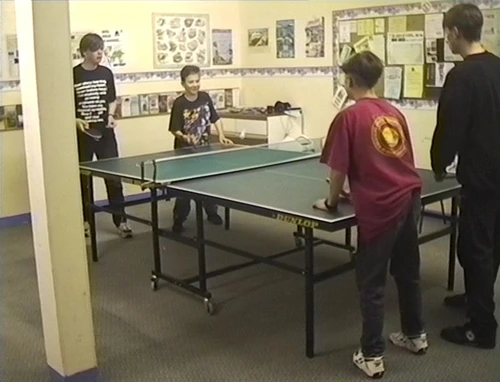 Neil, Eliot and Tao are joined by another hosteller in the games room.