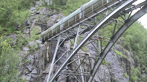 Why is this huge pipe bridged across the road rather than buried? 50.7 miles.