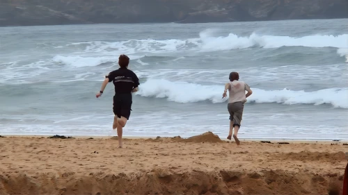 Harlyn Bay Beach: Joe and Josh feel the sea's pull despite the wind—34.5 miles in.