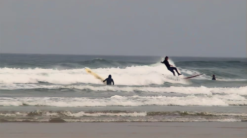 Surfers enjoying the waves at Perranporth Beach.