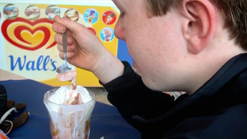 Joe tackles a Knickerbocker Glory at The Atlantic Café, Portreath seafront.