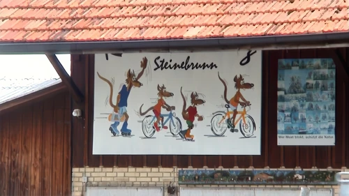 Charming farm‑shop sign beside the Steinebrunn cheese factory.