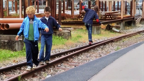 Tao catches a rail‑walker falling off.