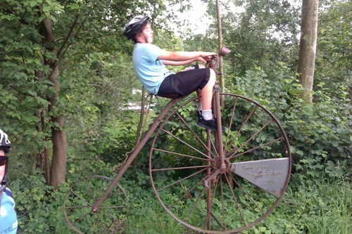 Lawrence tries the penny-farthing at the River Reuss Sculpture Park, beside Route 9, 1.6 miles from the hostel.
