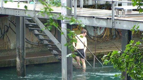 Ash reaches Zurich’s Public River Swimming the hard way—via the river; the door’s locked.