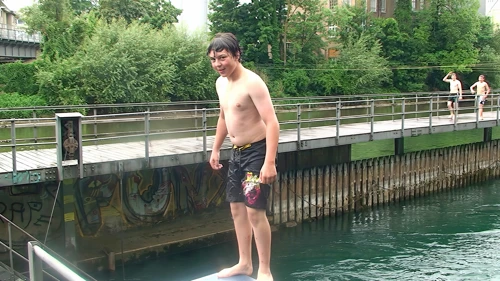 Lawrence prepares to fall into the river backwards.