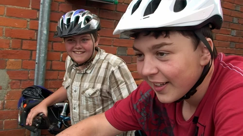 Lawrence proudly brandishes bacon for supper from Tesco Express, Brockenhurst.