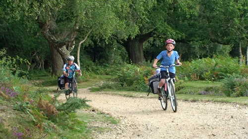 John and George approach Cater's Cottage on the old railway path from Brockenhurst, 11.3 miles in.