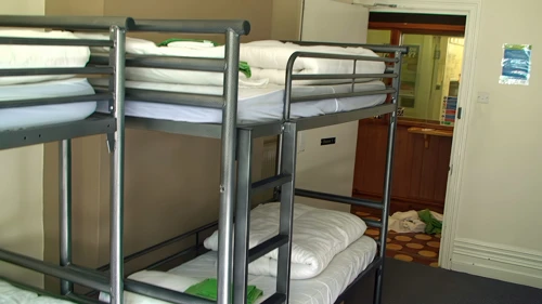 Adequate metal bunks in our ground-floor dorm at Burley Youth Hostel; reception opposite.